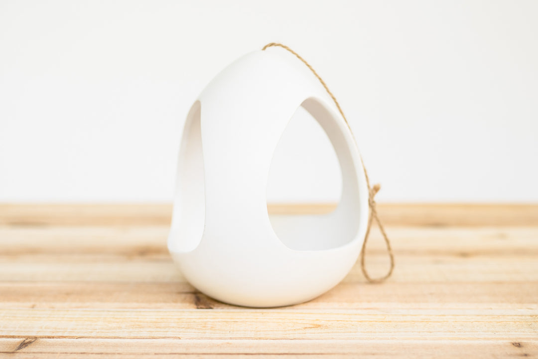 large white ceramic hanging pod