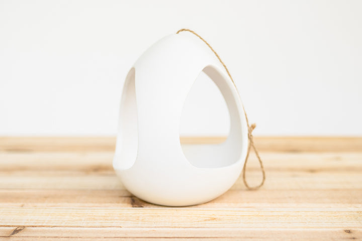large white ceramic hanging pod