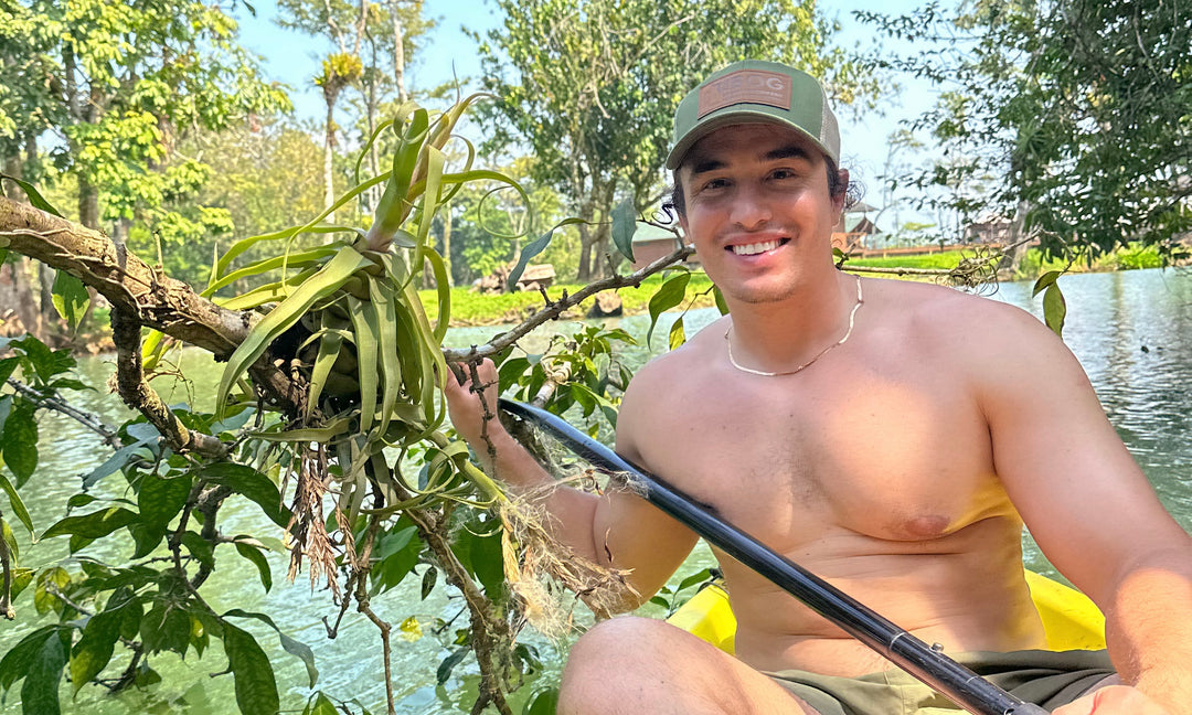 christian on a kayak finding tillandsia air plants in Guatemala