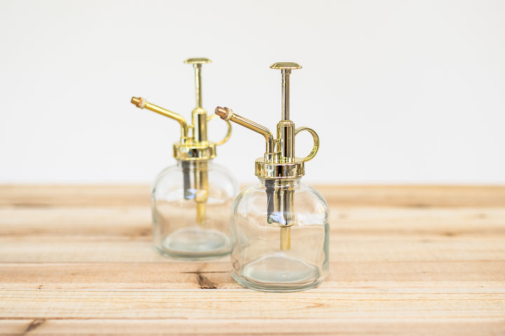 glass mister with gold colored pump