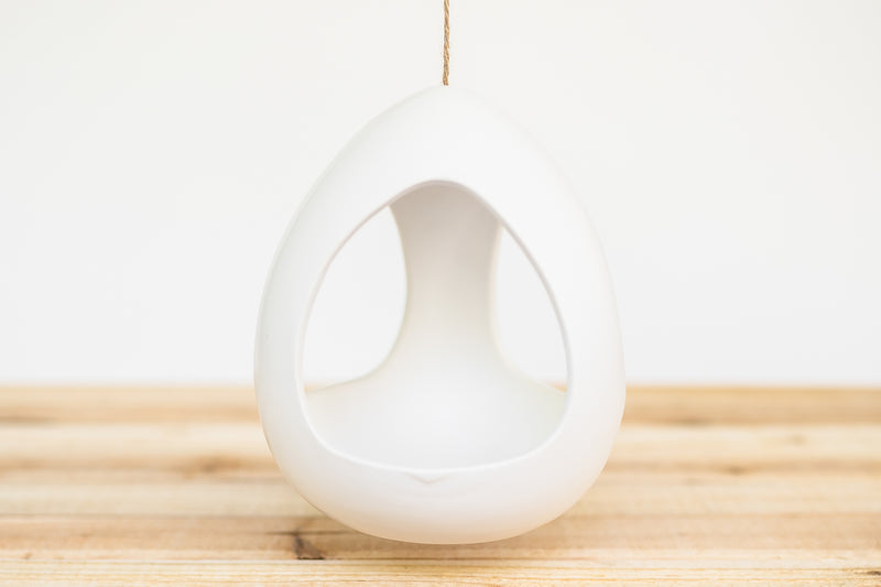 large white ceramic hanging pod