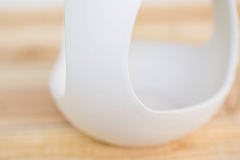 close up of large white ceramic hanging pod